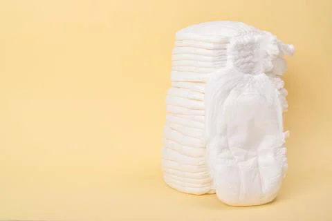 A large stack of disposable panties on a yellow background. Stock Photos