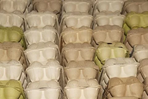 A large stack of empty cardboard egg containers in a warehouse for distribution Stock Photos