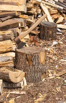 Large stack of firewood with axe. Stock Photos