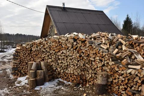 Large stack of firewood in the countryside Stock Photos