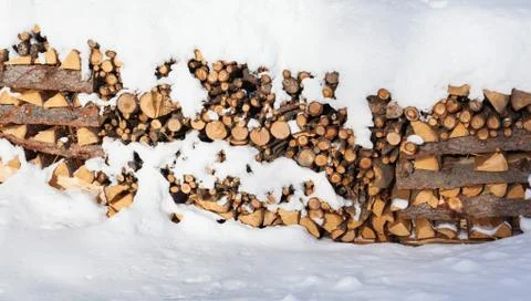 Large Stack of Firewood Piled Outside in the Snow Stock Photos