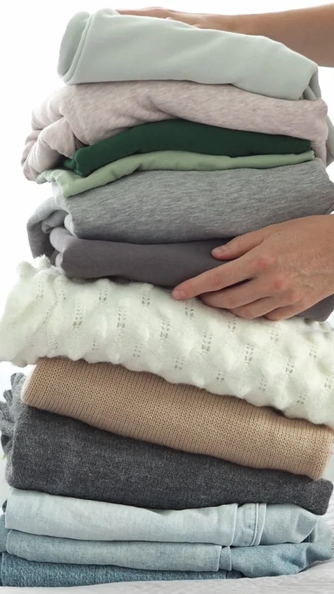 A large stack of folded clothes for recycling. The background is made of old clo Stock Footage 281340436