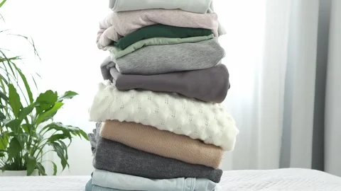 A large stack of folded clothes for recycling. The background is made of old clo Stock Footage 281340487