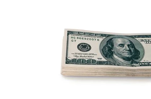 A large stack of hundred-dollar cash bills on a white background. Isolated. Stock Photos