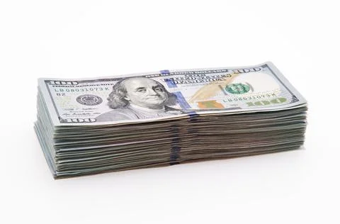 A large stack of hundred-dollar cash bills on a white background. Isolated. Stock Photos