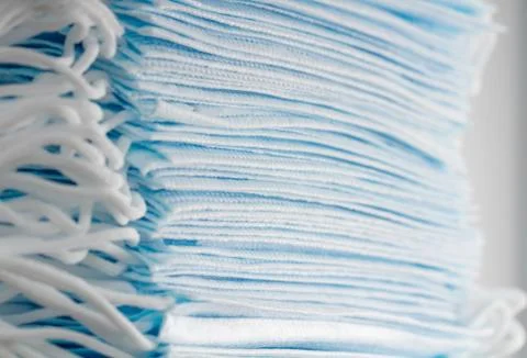 Large stack of medical disposable face masks close-up. Stock Photos