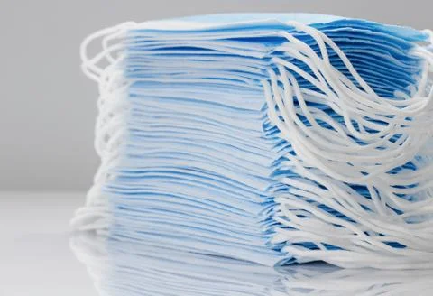 Large stack of medical disposable face masks close-up. Stock Photos
