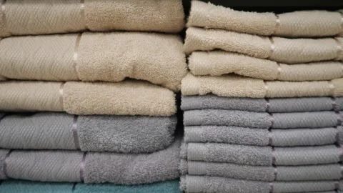 Large stack of multi-colored towels. Towels on a shelf. Video stock 309883366