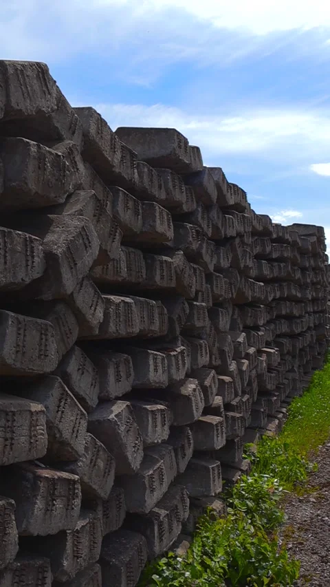 Large Stack of Old Concrete Railroad Ties Outdoors Stock Footage 338026771