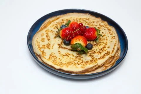A large stack of pancakes with red sweet berries Stock Photos