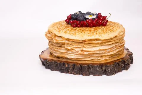 A large stack of pancakes with red sweet berries Stock Photos