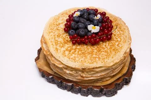A large stack of pancakes with red sweet berries Stock Photos