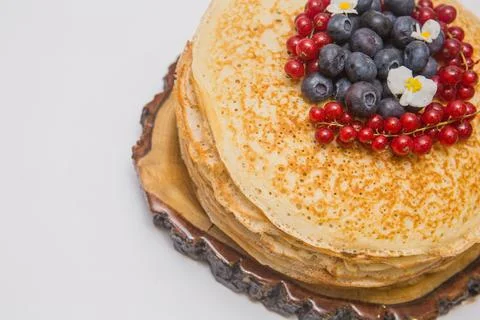 A large stack of pancakes with red sweet berries Stock Photos