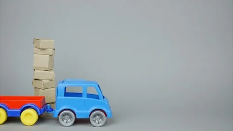 A large stack of parcels. A delivery vehicle arrives, loads parcels and leaves Stock Footage 103631332