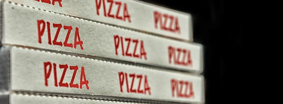 Large stack of pizza boxes. Isolated over black Foto stock