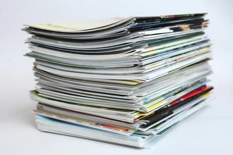 A large stack of printing magazines on a white background. Lots of different  Stock Photos
