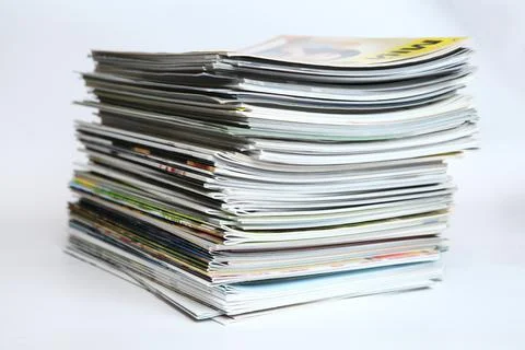 A large stack of printing magazines on a white background. Lots of different  Stock Photos