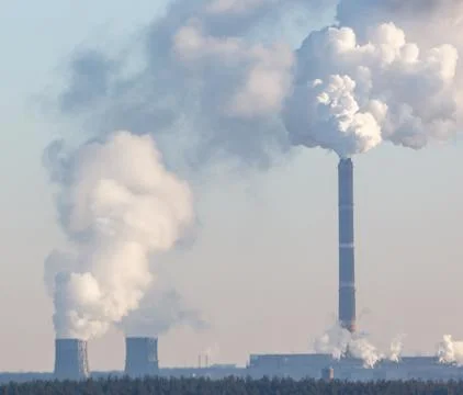 A large stack of smoke is coming out of a power plant 스톡 사진