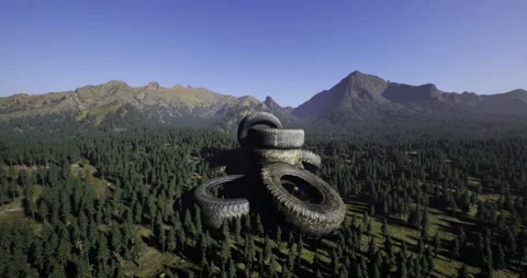 Large stack of tires in mountainous forest landscape during clear day Stock Footage 317515260