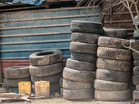 Large Stack of Used Old Car Tires in Industrial Scrap Yard Stock Photos