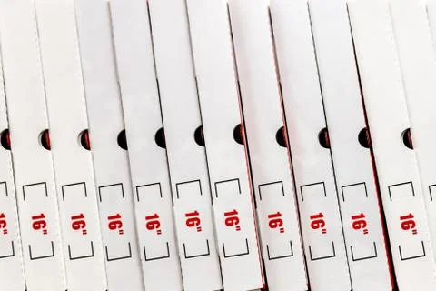 A large stack of white pizza boxes with red numbers. Stock Photos