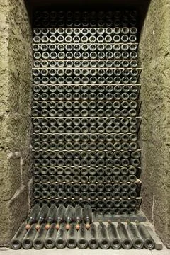 Large Stack of Wine Bottles in a Stone Cellar Fotos Stock