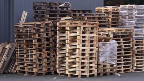 Large Stack of Wooden Euro Pallets Stored Outdoors in Industrial Warehouse Yard Stock Footage 323330687