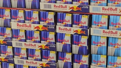 Large stacked display of various Red Bull energy drink four-packs 스톡 동영상 341459783