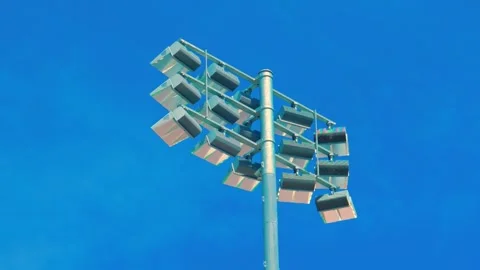 Large stadium floodlight pole against blue sky 動画素材 338352726