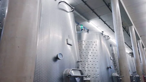 Large stainless tanks for high quality wine production, metal barrels with pipes Video stock 296759993