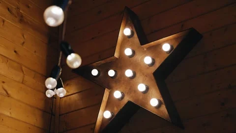 A large star with light bulbs decorates and illuminates the room Stock Footage 263967966