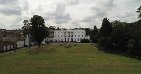 Large stately home revealed from behind trees drone aerial 4k Stock Footage 124647403