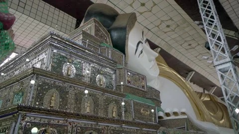 A large statue of Buddha is surrounded by flowers Stock Footage 313371404