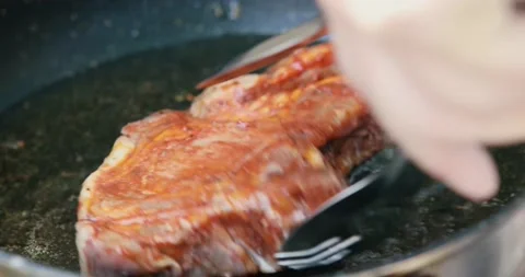 Large steak meat fried in boiling oil close up Stock Footage 130770480