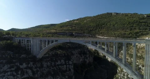 Large stone bridge across huge canyon in French countryside drone aerial 4k Stock Footage 125755775