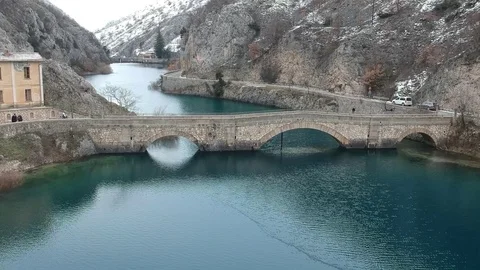 A large stone bridge over a lake Stock Footage 114749007