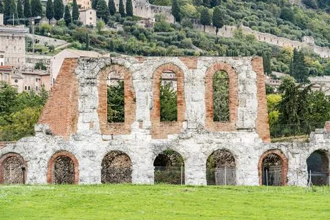 A large stone building with arched windows and a courtyard in Gubbio Italy .. Stock Photos