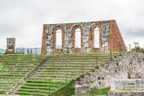 A large stone building with arched windows and a courtyard in Gubbio Italy .. Stock Photos