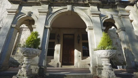 A large stone building with a large archway and a large door Stock Footage 302481271