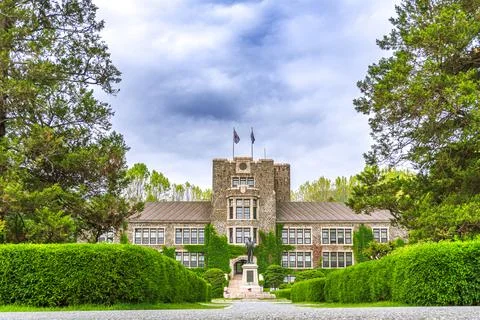 Large stone building with a statue in front of it Stock Photos