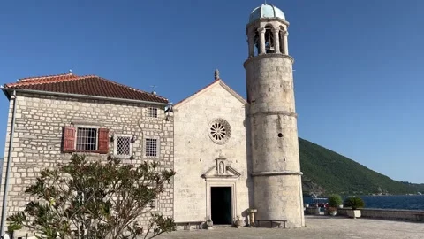 A large stone church with a clock tower on top of it Stock Footage 268239054