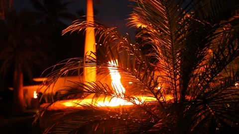 Large stone concrete fire pit burning at night. Tropical loaction Stock Footage 107279396