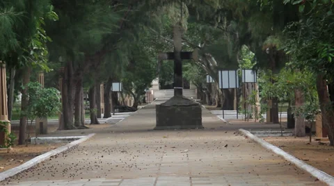 Large stone cross in the path with wind in tress Stock Footage 34956366