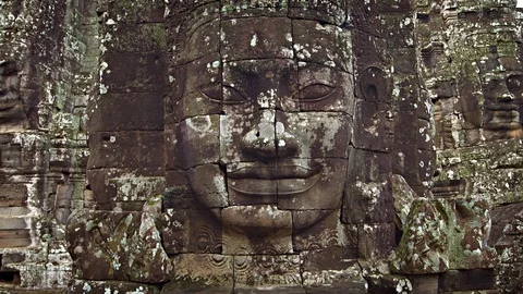 Large stone faces on the towers at The Bayon temple. Cambodia Stockbeeldmateriaal 74983888