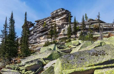 Large stone pillars and a wall in a mountainous area. Stock Photos