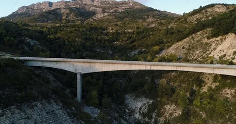 Large stone road bridge on a mountain in autumn drone aerial 4k Stock Footage 125755420