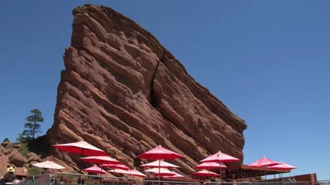Large Stone Rock Towering Over Outdoor Cafe Video stock 156215898