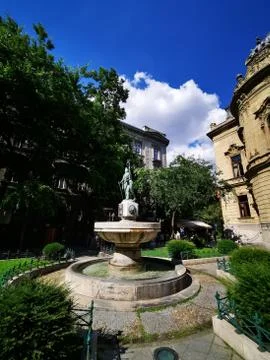 A large stone statue in front of a building Stock Photos