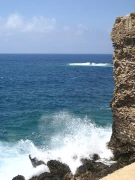 A large stone tower standing in the middle of a ocean, Stock Photos