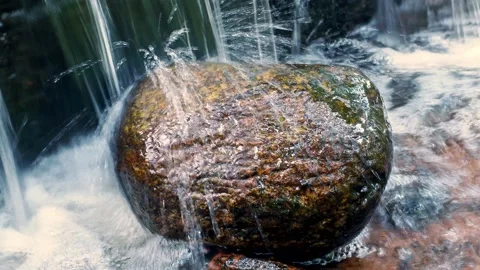 A large stone on which water flows Stock Footage 144673076